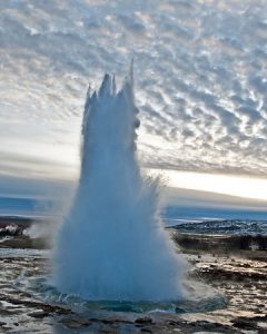 The golden circle geysir shoots up against a beautiful morning sky in Iceland
