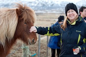 Annie pets the muzzle of a fuzzy Icelandic Horse