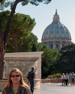 standing in front of a domed church in Italy