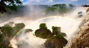 a rainbow over Iguazu Falls in Argentina