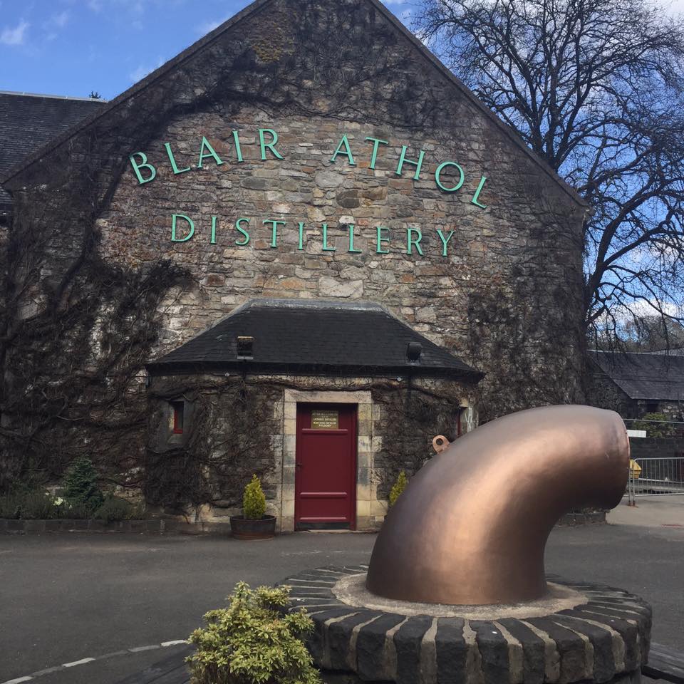 a large stone building shows the front of the Blair Athol Whisky Distillery in Scotland