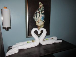two towels folded to look like swans forming a heart in the honeymoon suite in Grenada