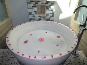 a private bath with flowers and flower petals in Grenada