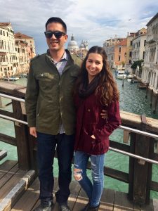 young couple standing on the Academia Bridge in Venice 