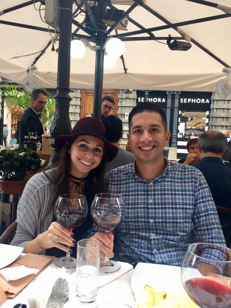 young couple with two wine glasses at lunch in Milan Italy
