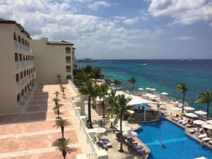 looking over the pool and beautiful blue waters of the Cozumel Palace in Mexico
