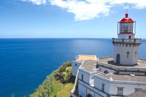 the Faro do Arnel lightouse and azure sea beyond on the Azores Islands in Portugal