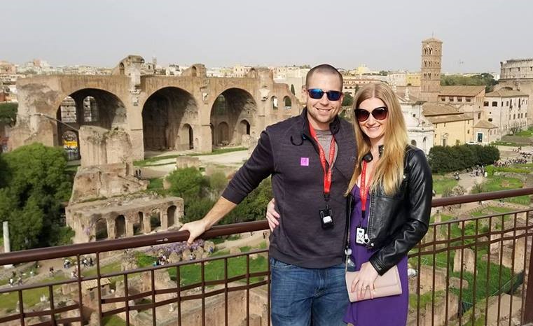a couple in front of ancient roman ruins in italy