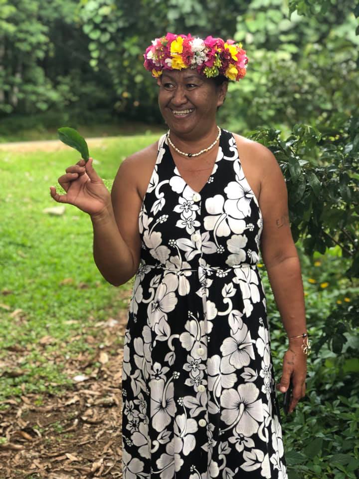 a woman in flower crown holding leaf Moorea