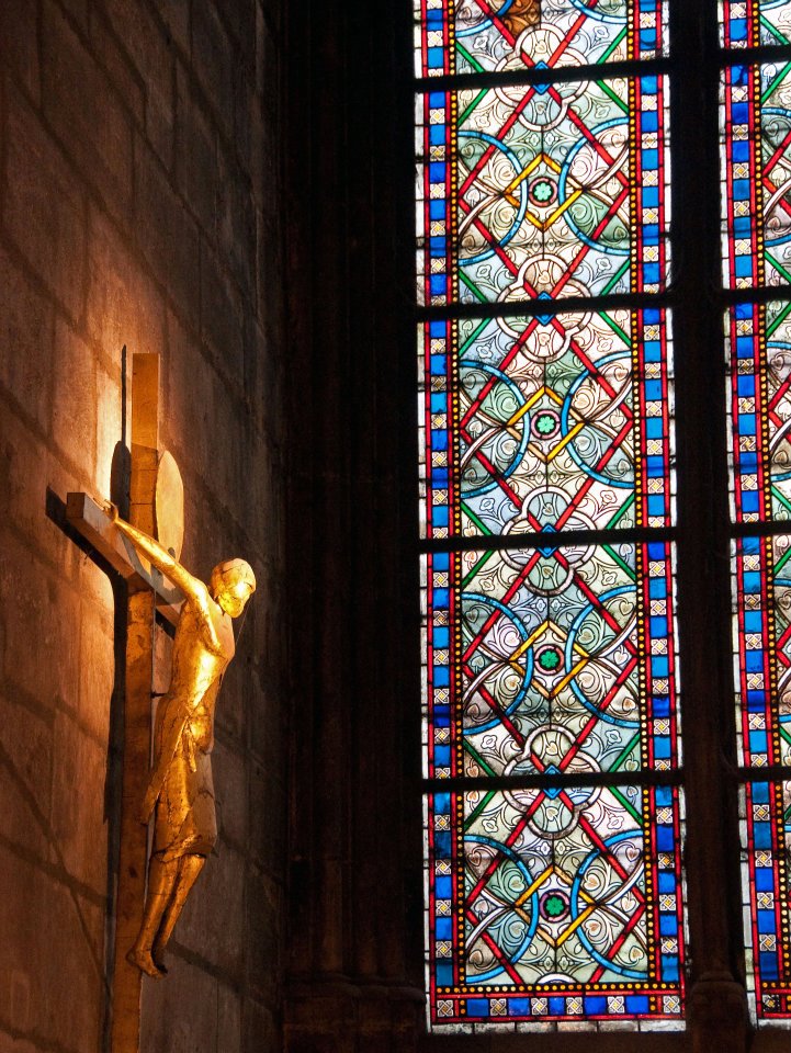 stained glass window and crucifix in Notre Dame