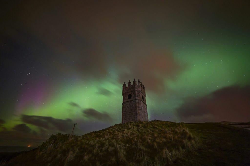 northern lights behind Scottish monument