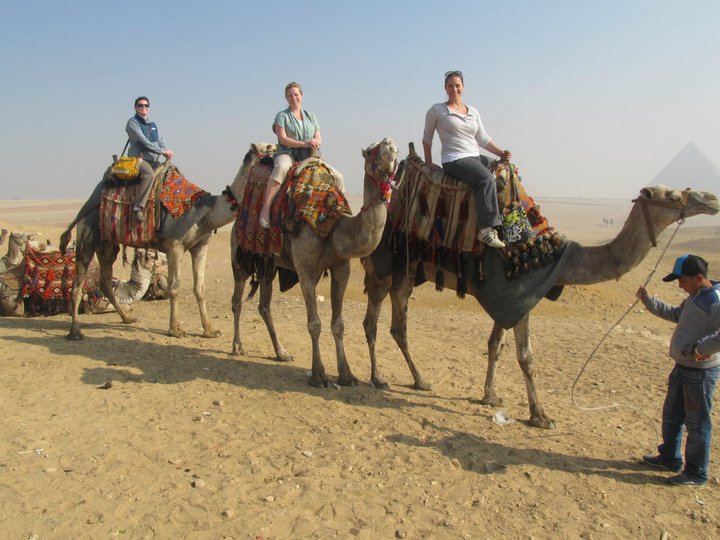 three women on three camels in Egypt