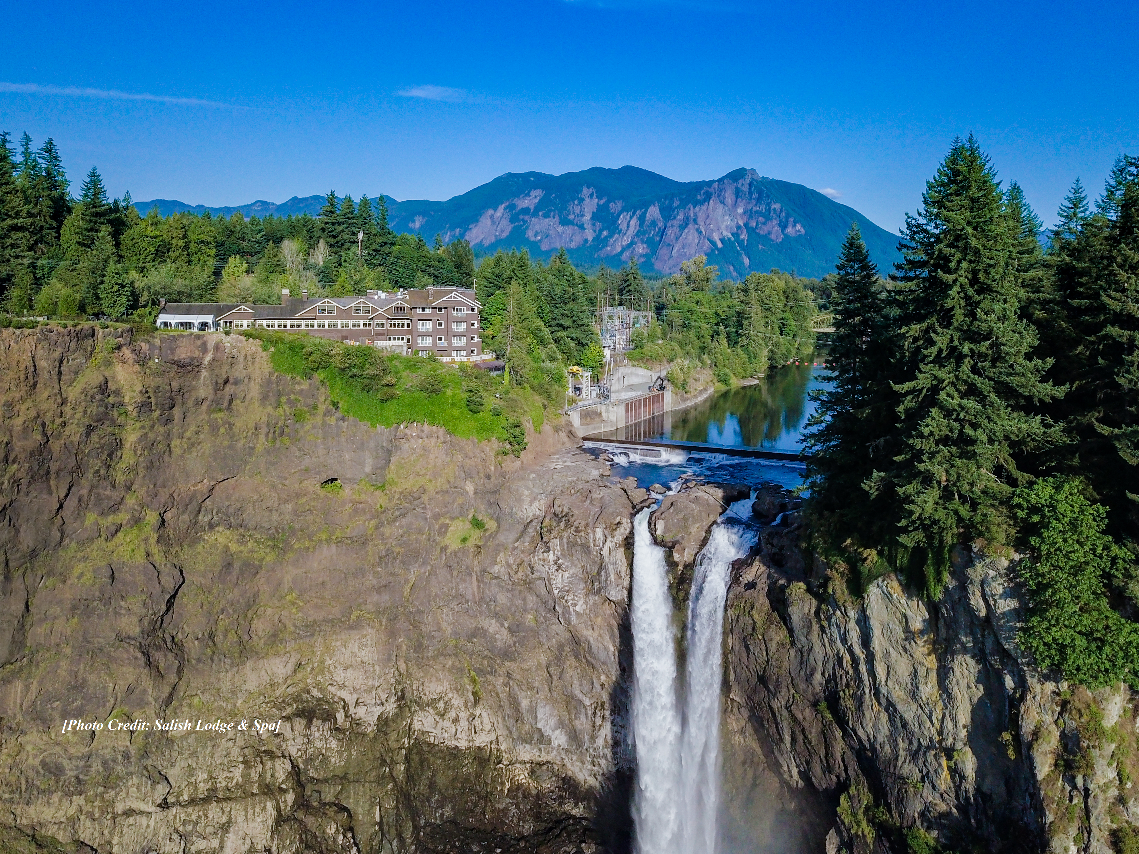 aerial Salish lodge and spa sitting atop the large waterfall in washington state