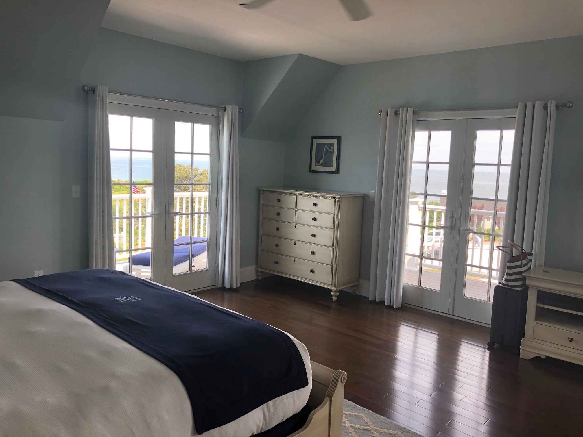 king corner hotel room in Block Island Rhode Island set in blue tones with two windows