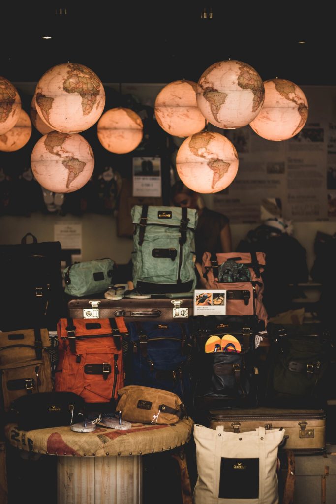 illuminated globe lights over piles of luggage - what travel gift to give an aquaintence