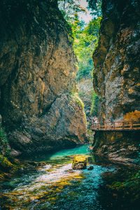 light shines onto the small river through the gorge with boardwalk on the side in Vintgar Gorge Slovenia