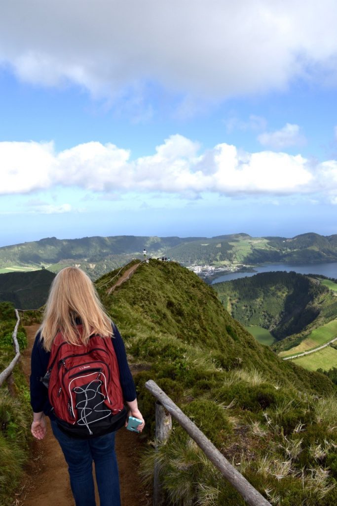 Ann hiking along a path on top of the hilly and lush green Azores Islands