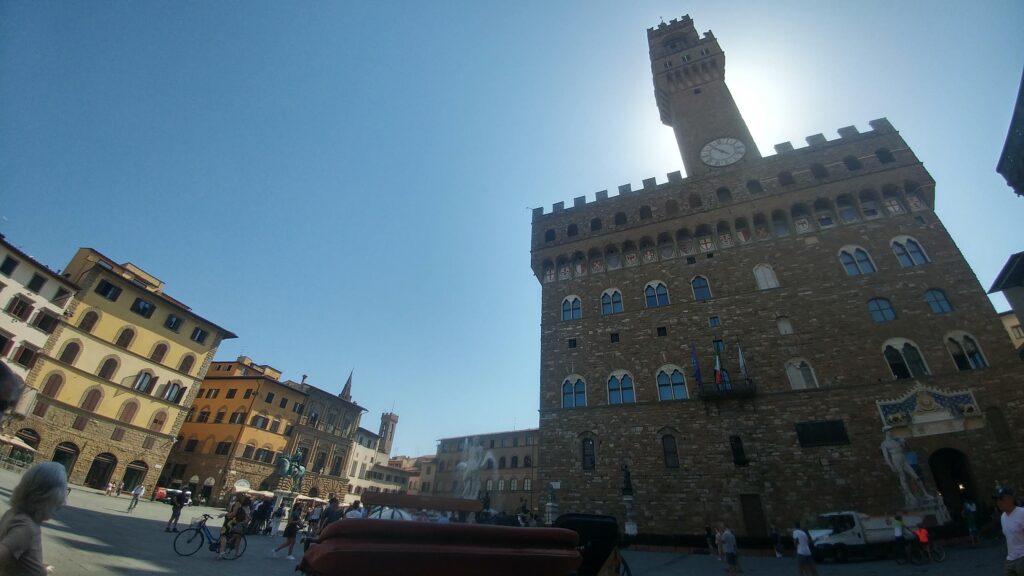 horse drawn carriages and people in Piazza della Signoria Florence Italy