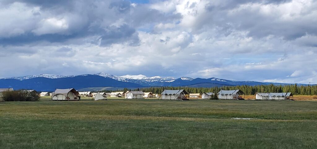stunning snow-capped mountains set behind a Glamping campsitein Wyoming