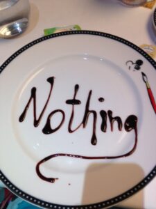 a plate of "nothing" with nothing written in chocolate