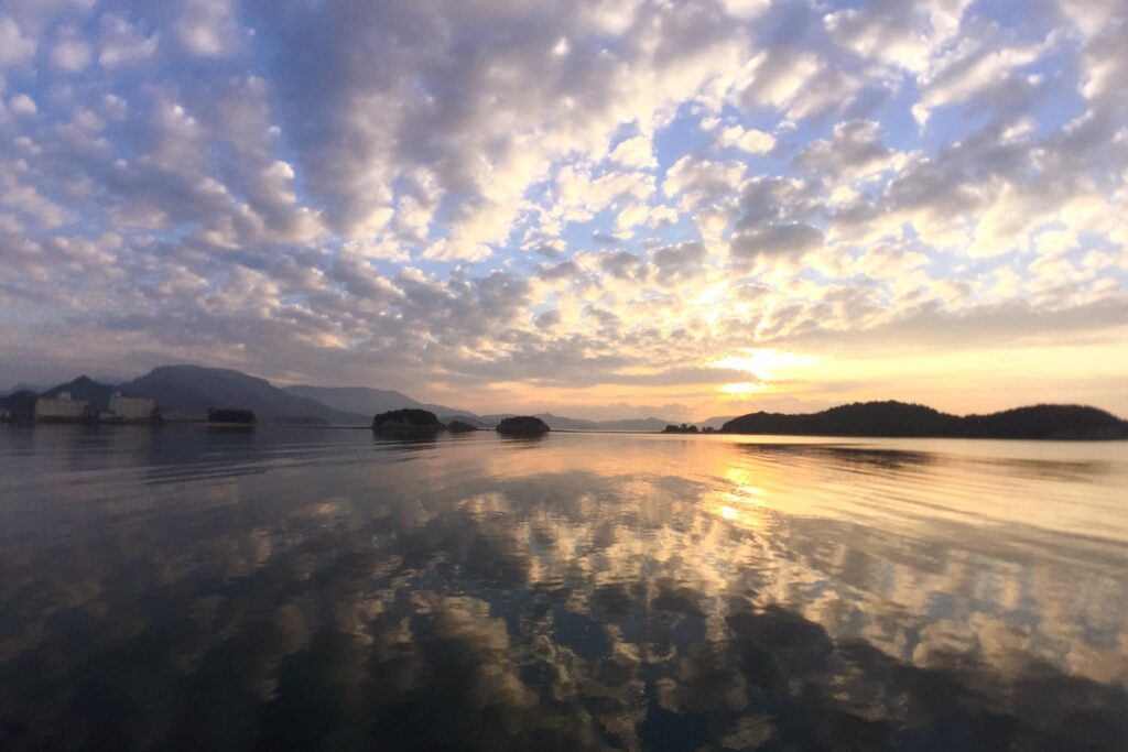 a sunset streaming over the water of the Setouchi region of Japan