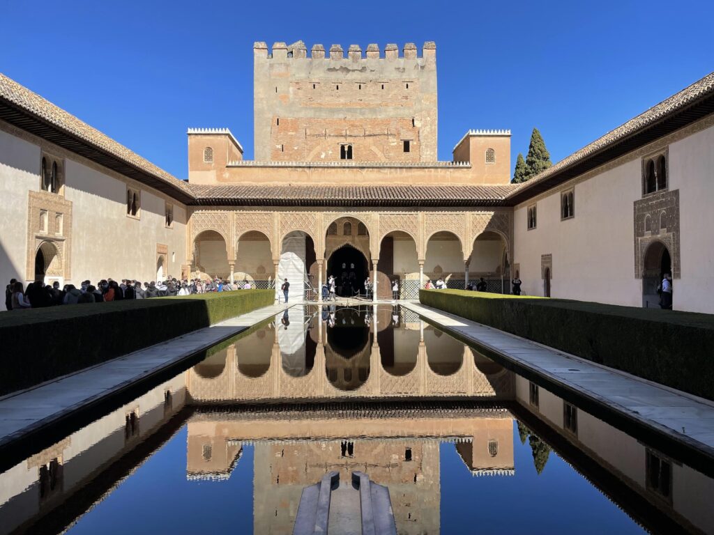 interesting architecture reflected in a long pool at Alhambra in Grenada Southern Spain