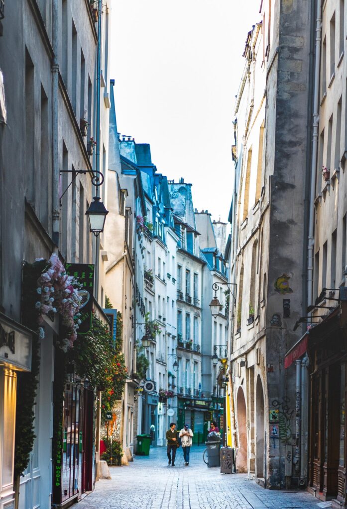 a narrow cobblestone street in Le Marais Paris
