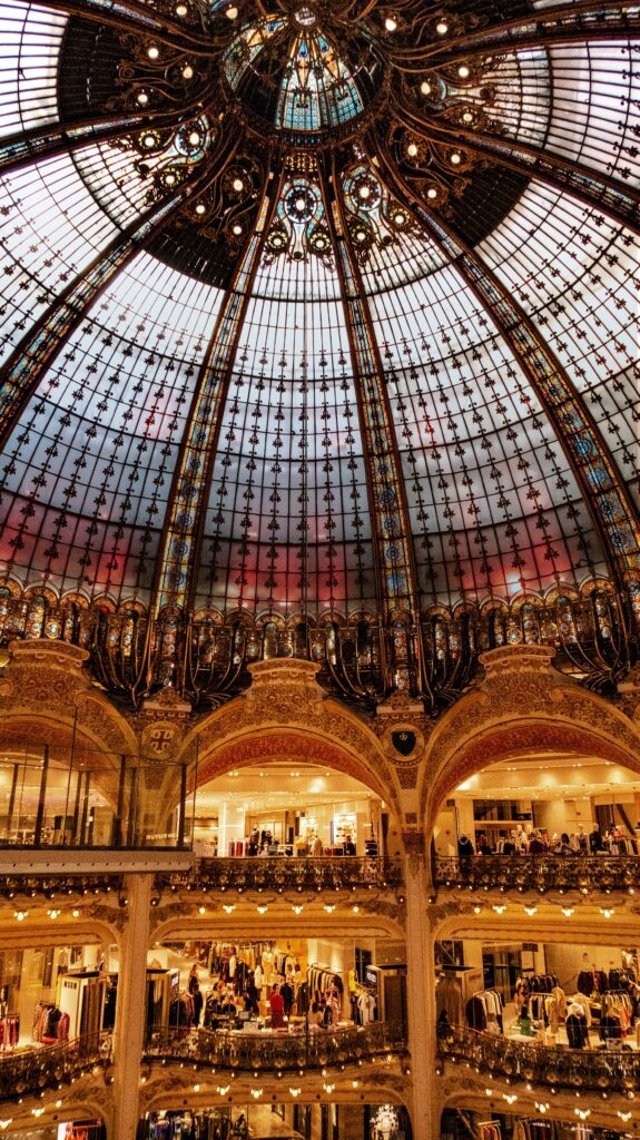 the domed glass ceiling and elegant arches of Printemps Department Store in Paris