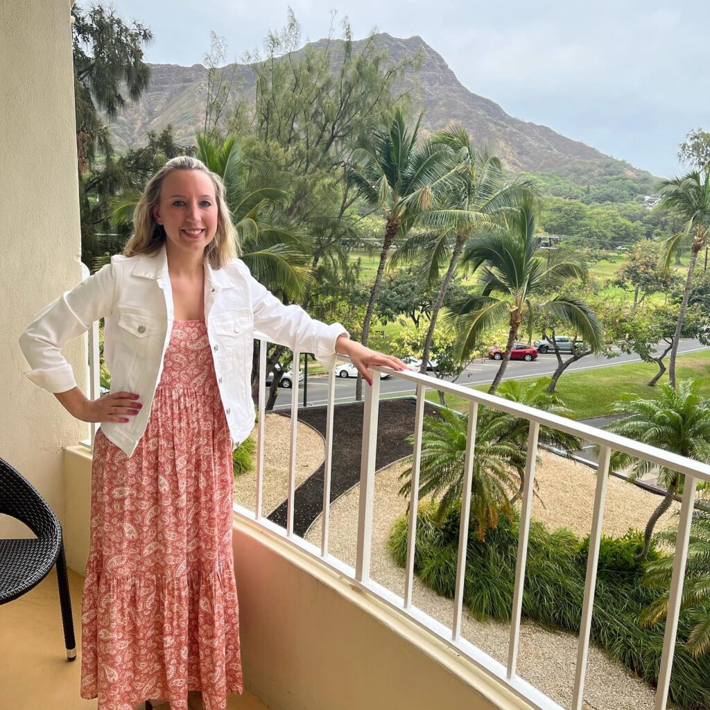 a woman standing on the resort balcony on her Hawaii Honeymoon