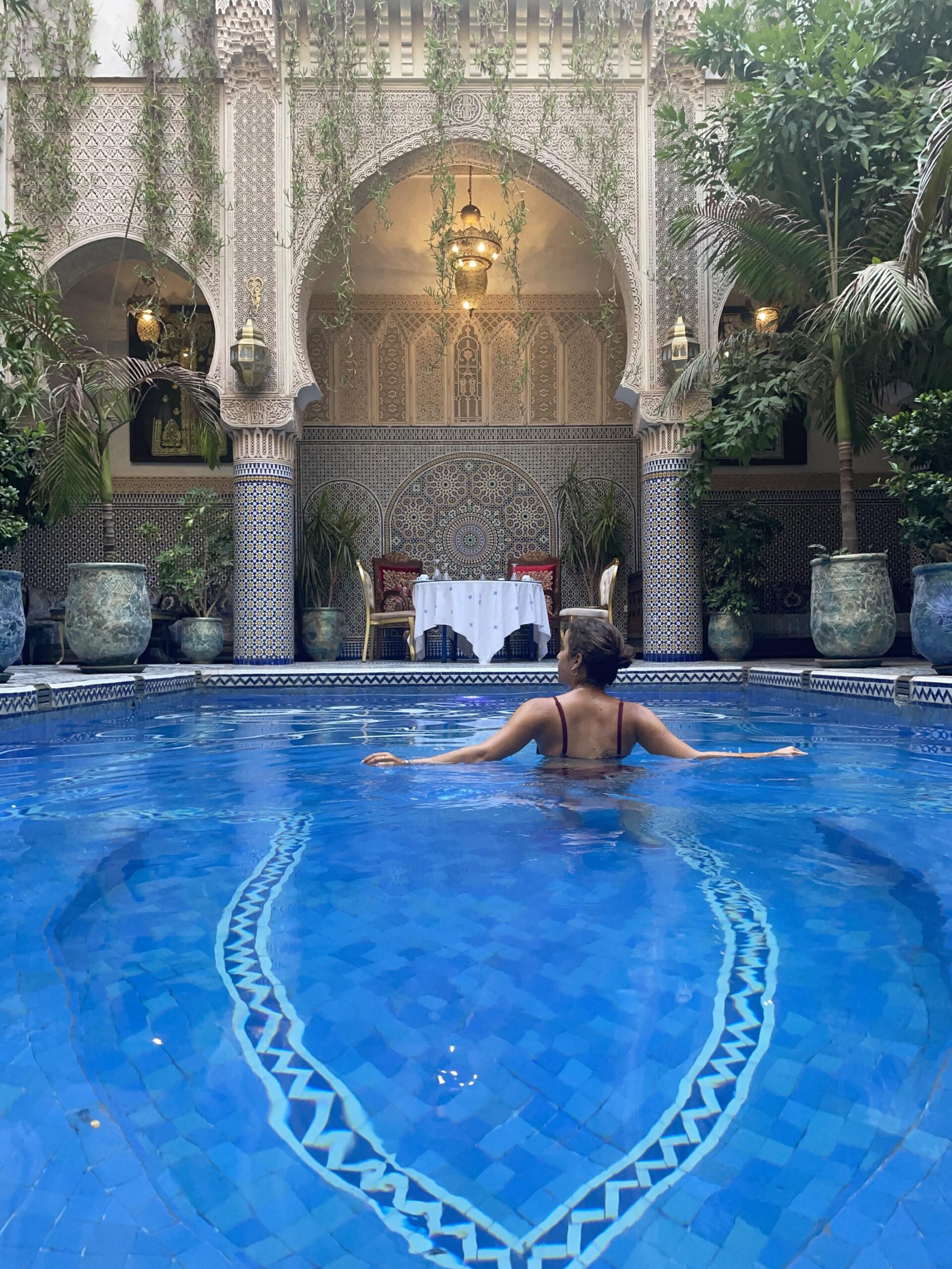 enjoying the pool surrounded by mosaics in the elegant Riad Salam in Fes Morocco