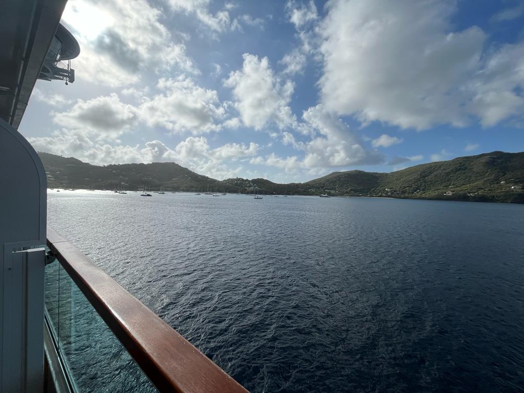 the view of beautiful green islands from the balcony of a small luxury cruise