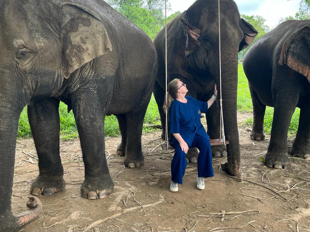 Ann next to an Elephant at the sanctuary in Thailand