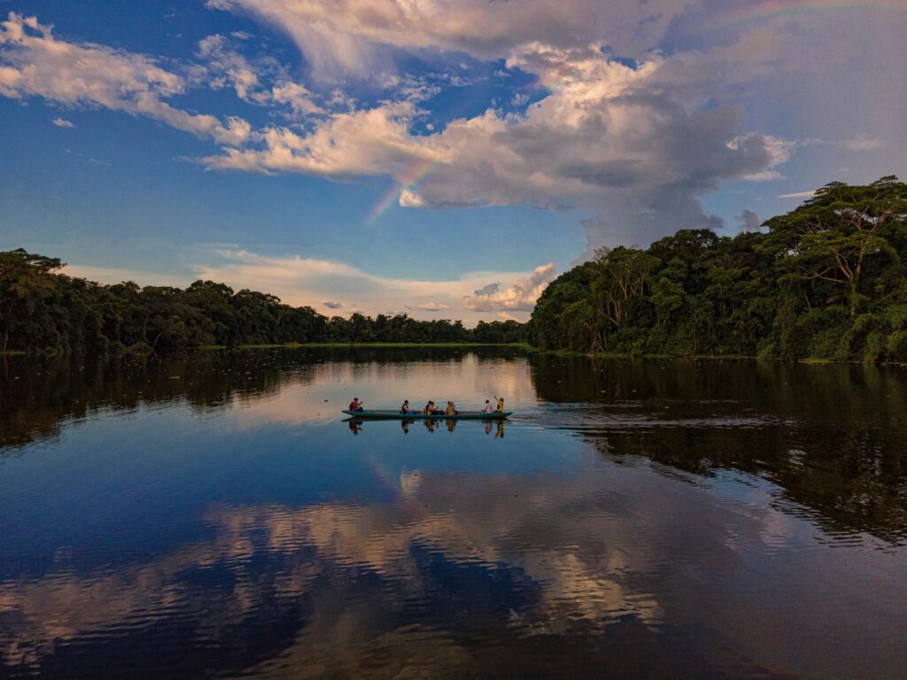 a canoe crossing the wide amazon river on an Amazon Expedition
