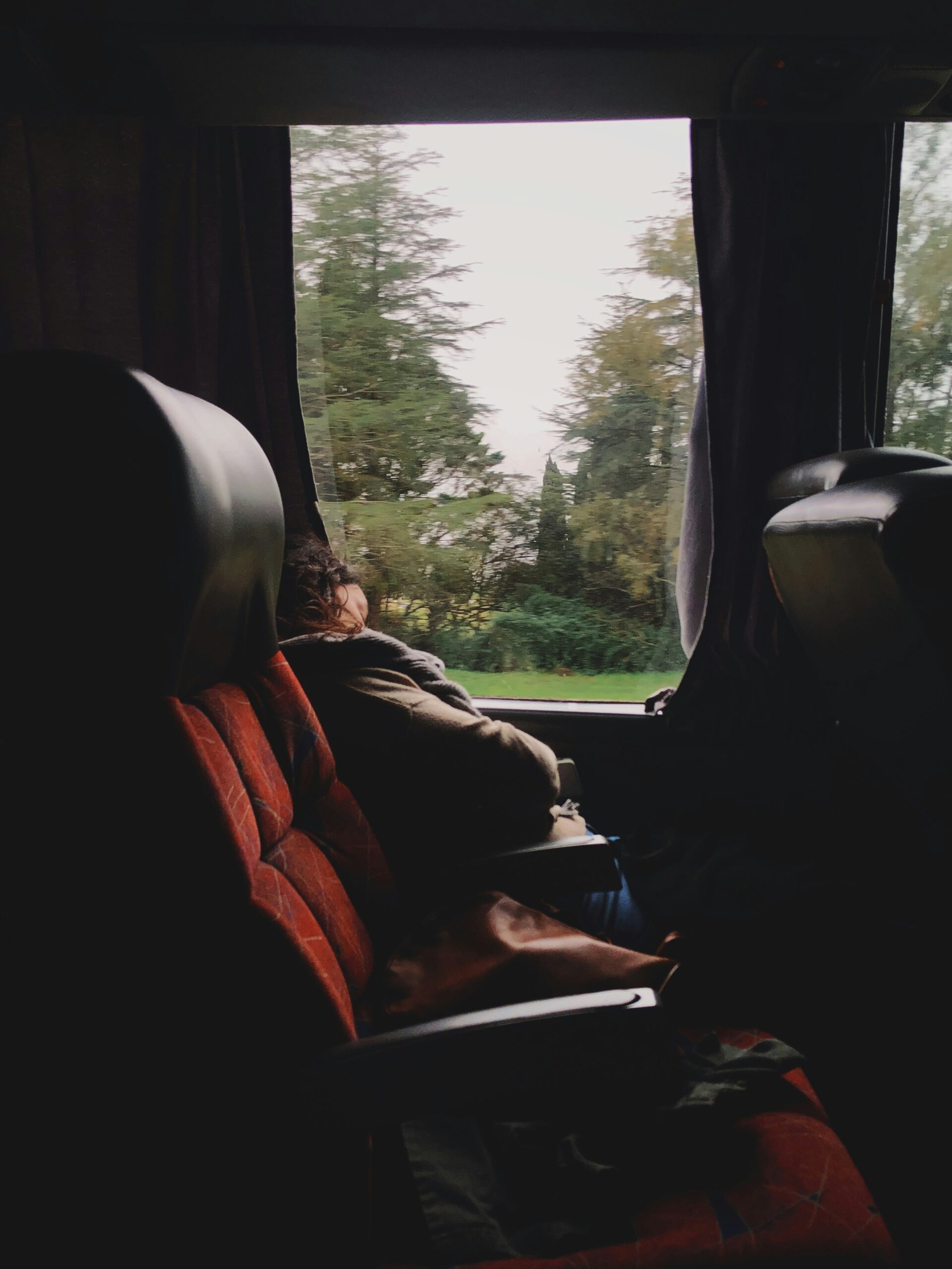 A person sleeping on a train